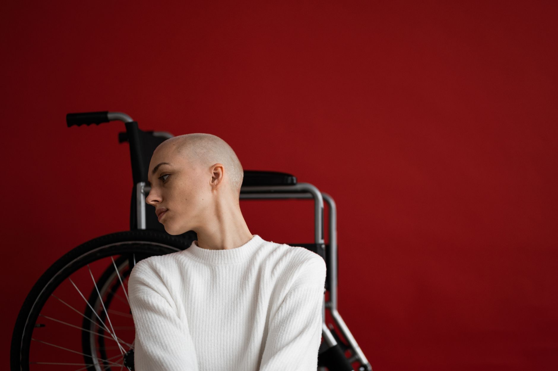 a person who uses a wheelchair looking forward with quiet resolve, catastrophic spinal injury