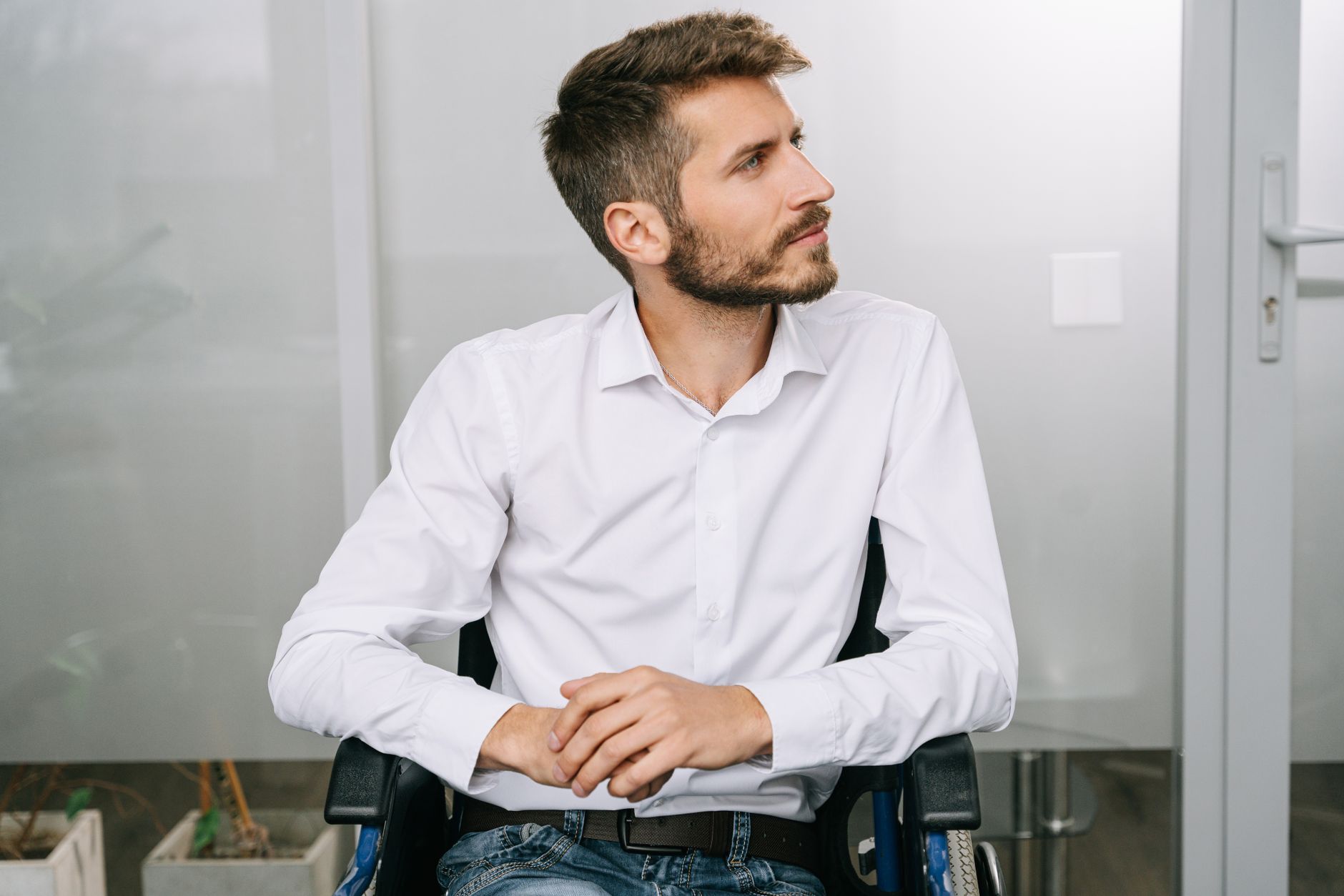 a person who uses a wheelchair looking forward with quiet resolve, catastrophic spinal injury
