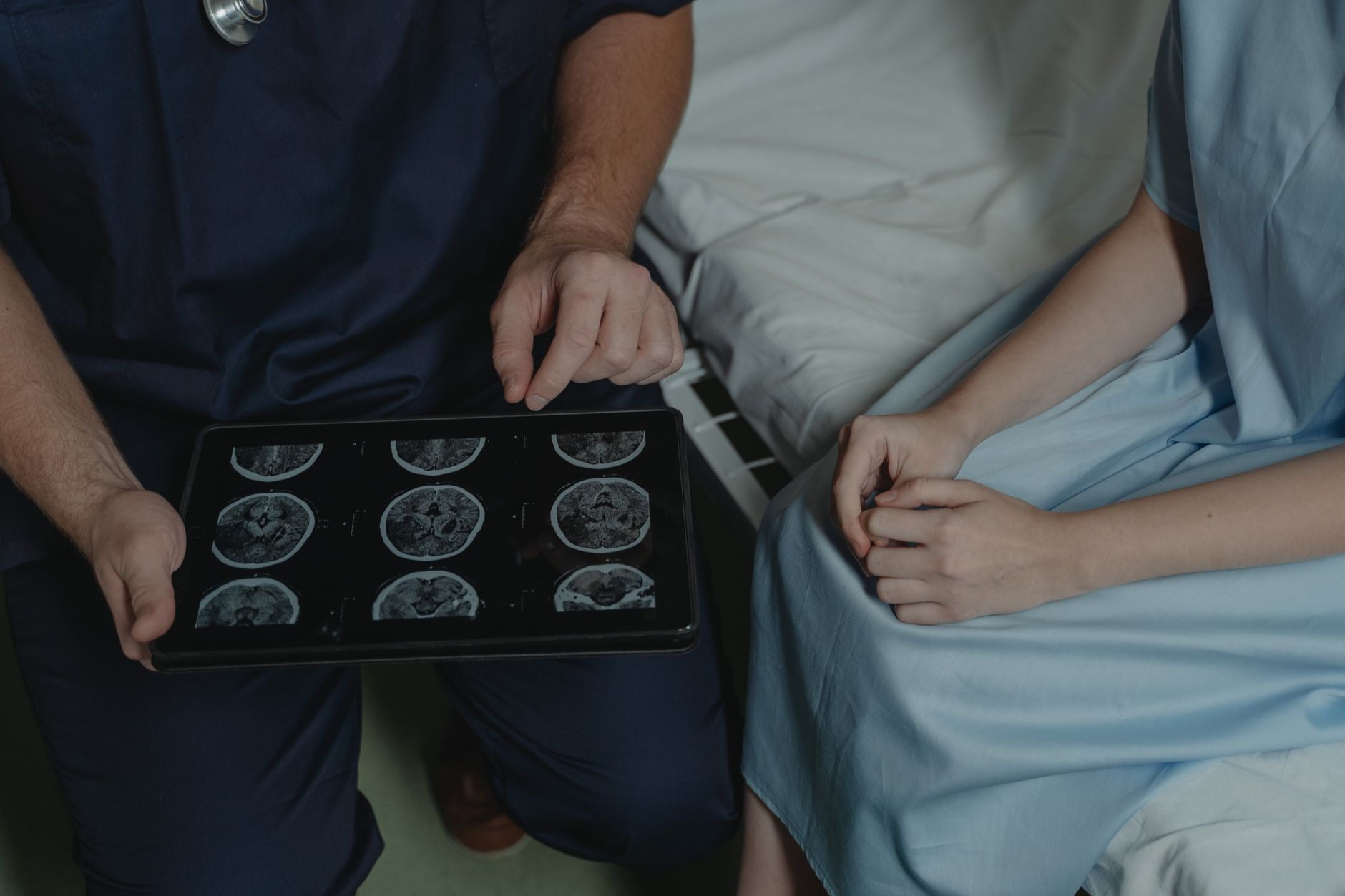 Doctor explains brain scan images to a patient in a medical office.
