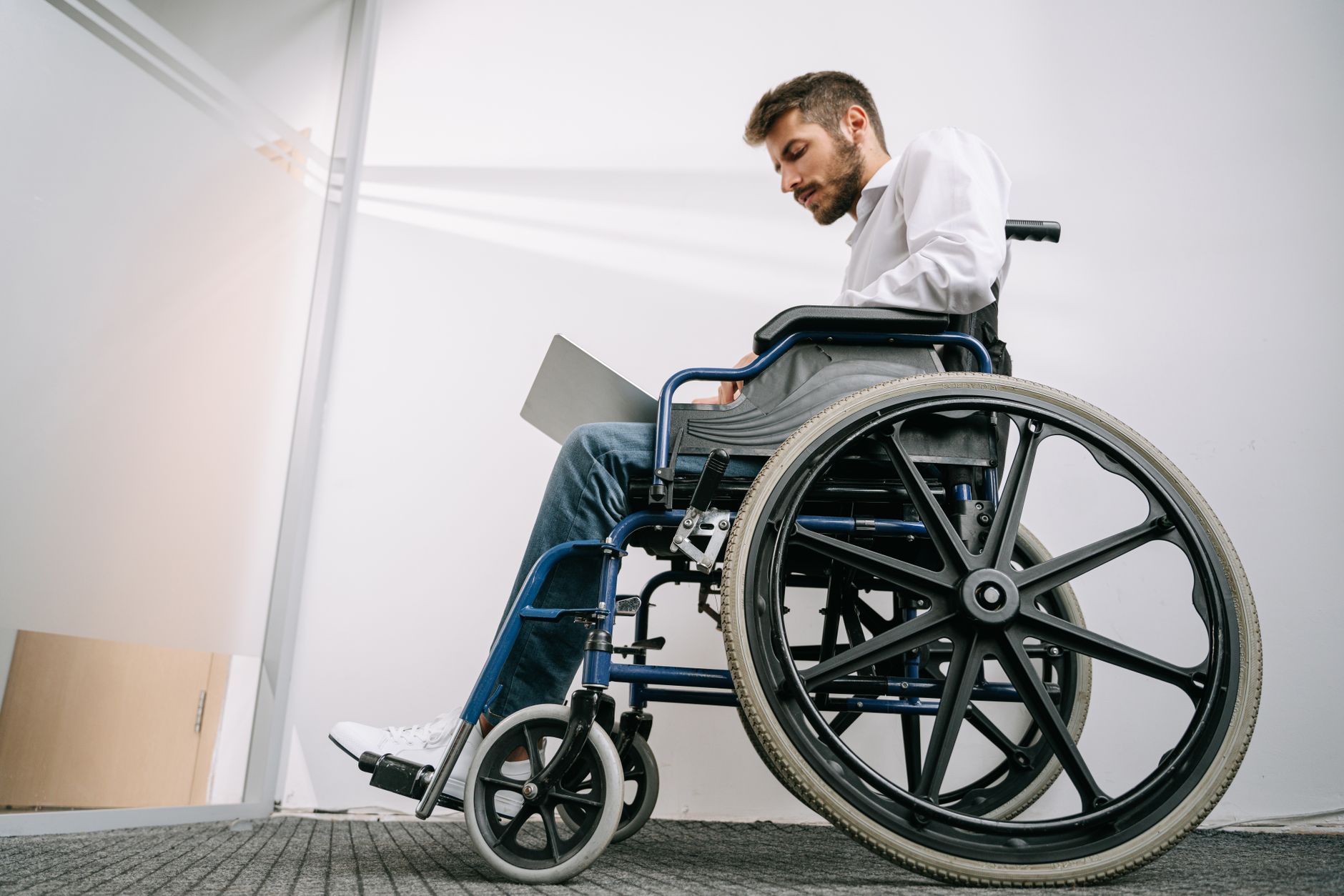a person who uses a wheelchair looking forward with quiet resolve, catastrophic spinal injury