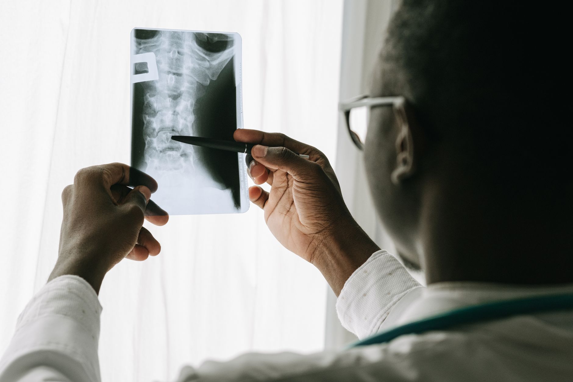 a neurosurgeon reviewing a cervical-spine MRI showing a spinal cord injury