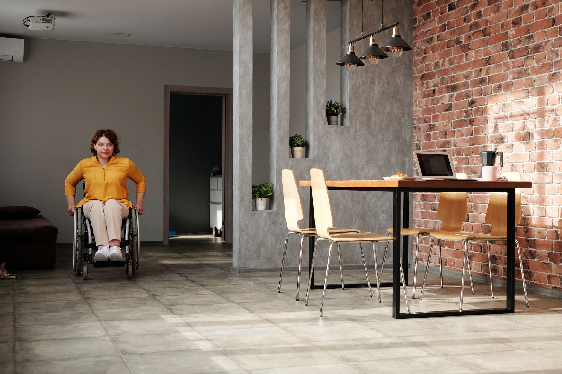 a wheelchair-accessibility ramp and adapted home modifications for a paralyzed person