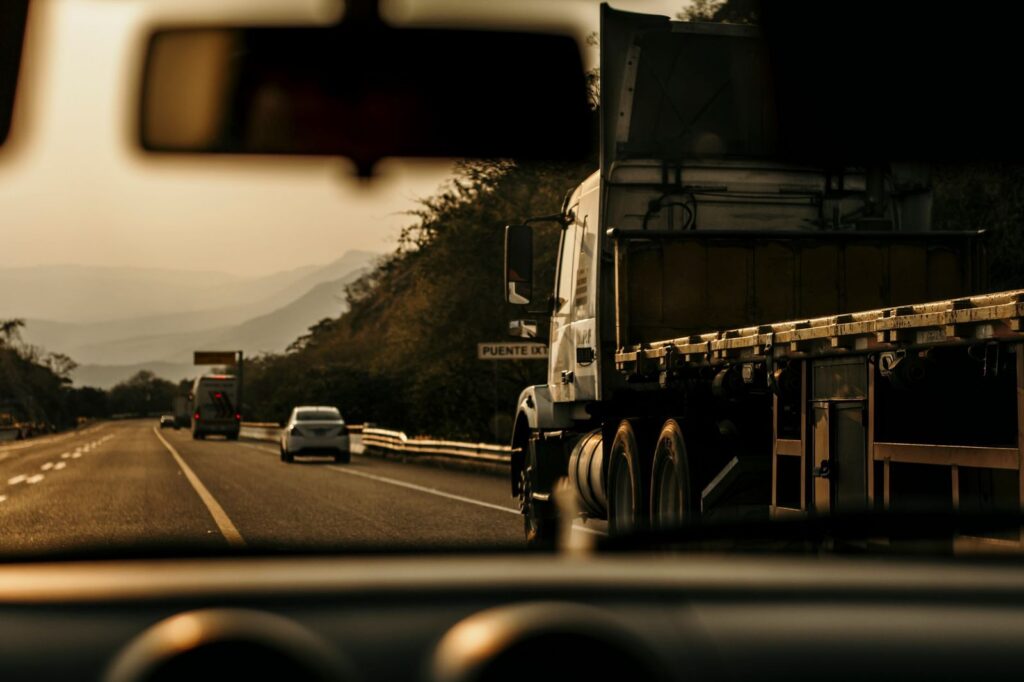 Cargo truck driving on highway at sunset in Tuxtla Gutiérrez.