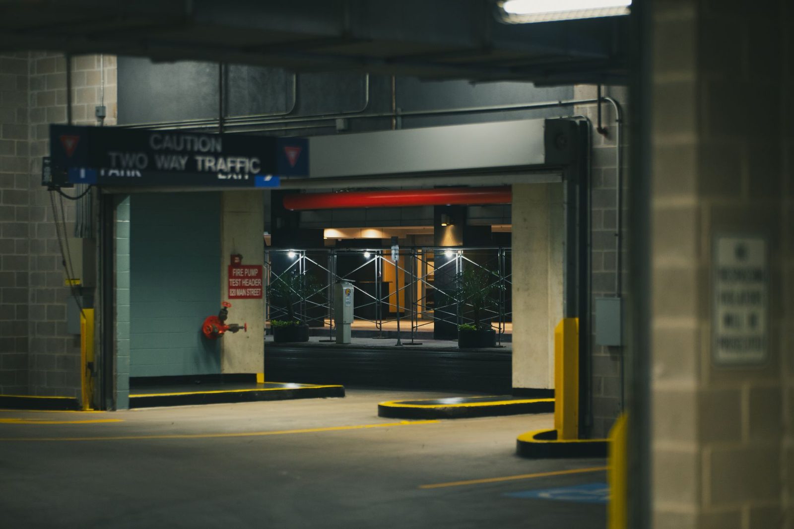 a dim, poorly lit parking garage at night suggesting inadequate property security