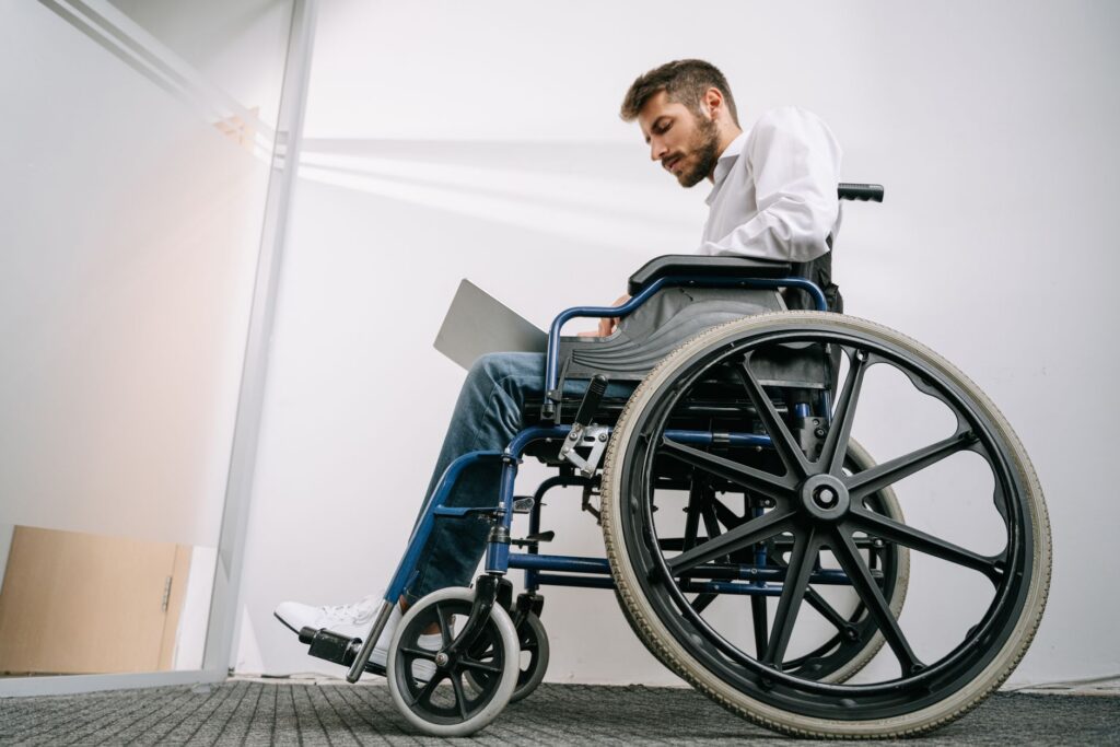 a person who uses a wheelchair looking forward with quiet resolve, catastrophic spinal injury