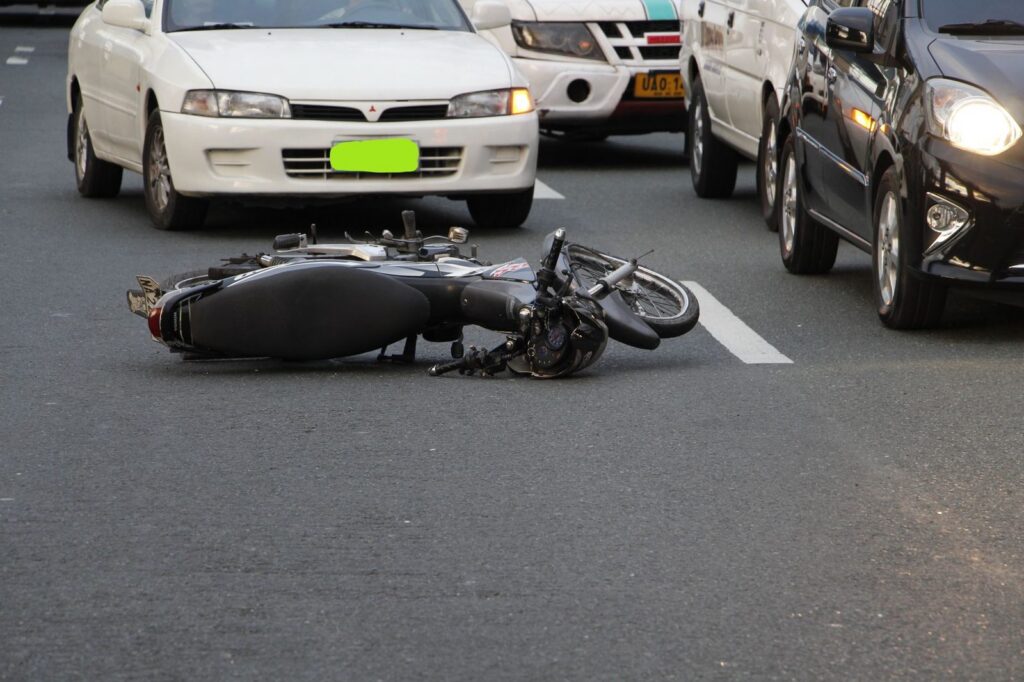 Motorcycle overturned on city street after accident.