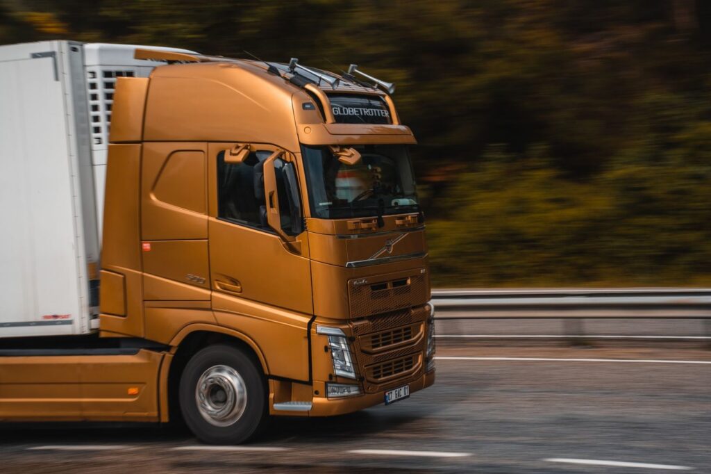 Orange truck driving on highway in Kemer.