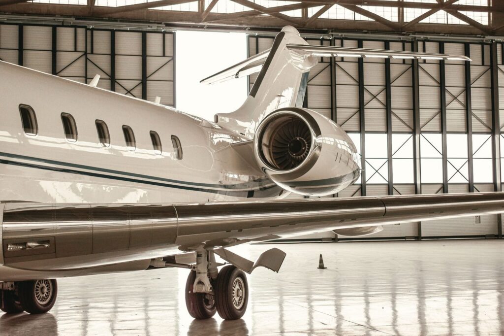Private jet parked in modern hangar.