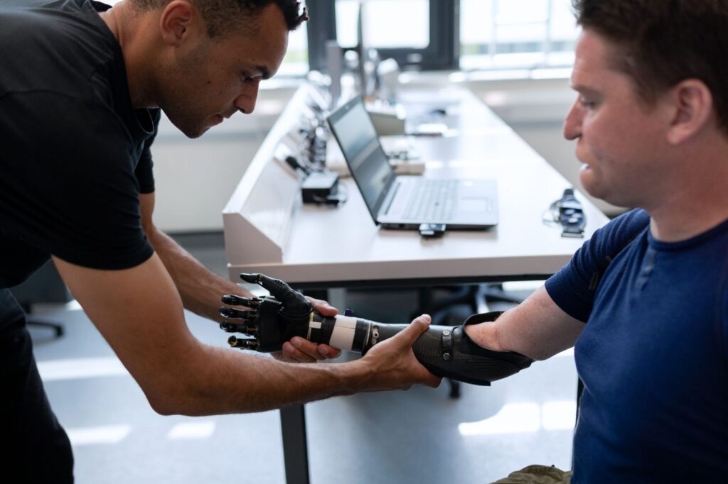 an amputation rehabilitation specialist fitting a comfortable prosthetic limb in a bright clinic