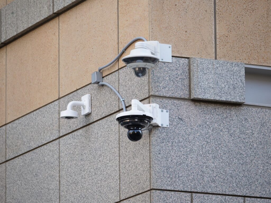 Security cameras mounted on a building wall for surveillance and safety.