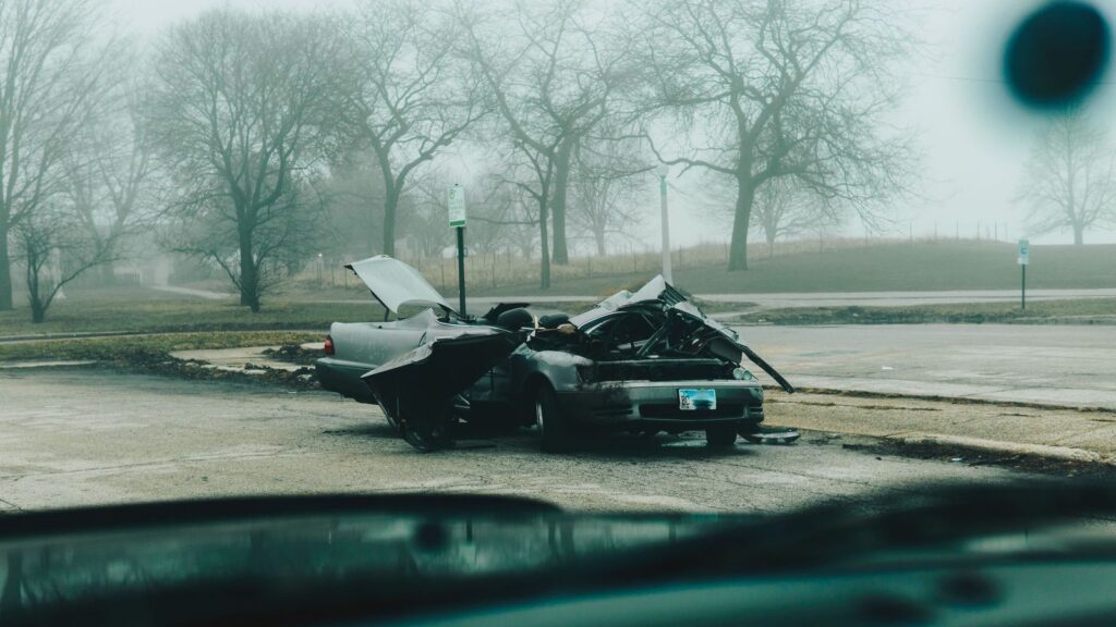 Severely damaged car on a foggy Chicago street.