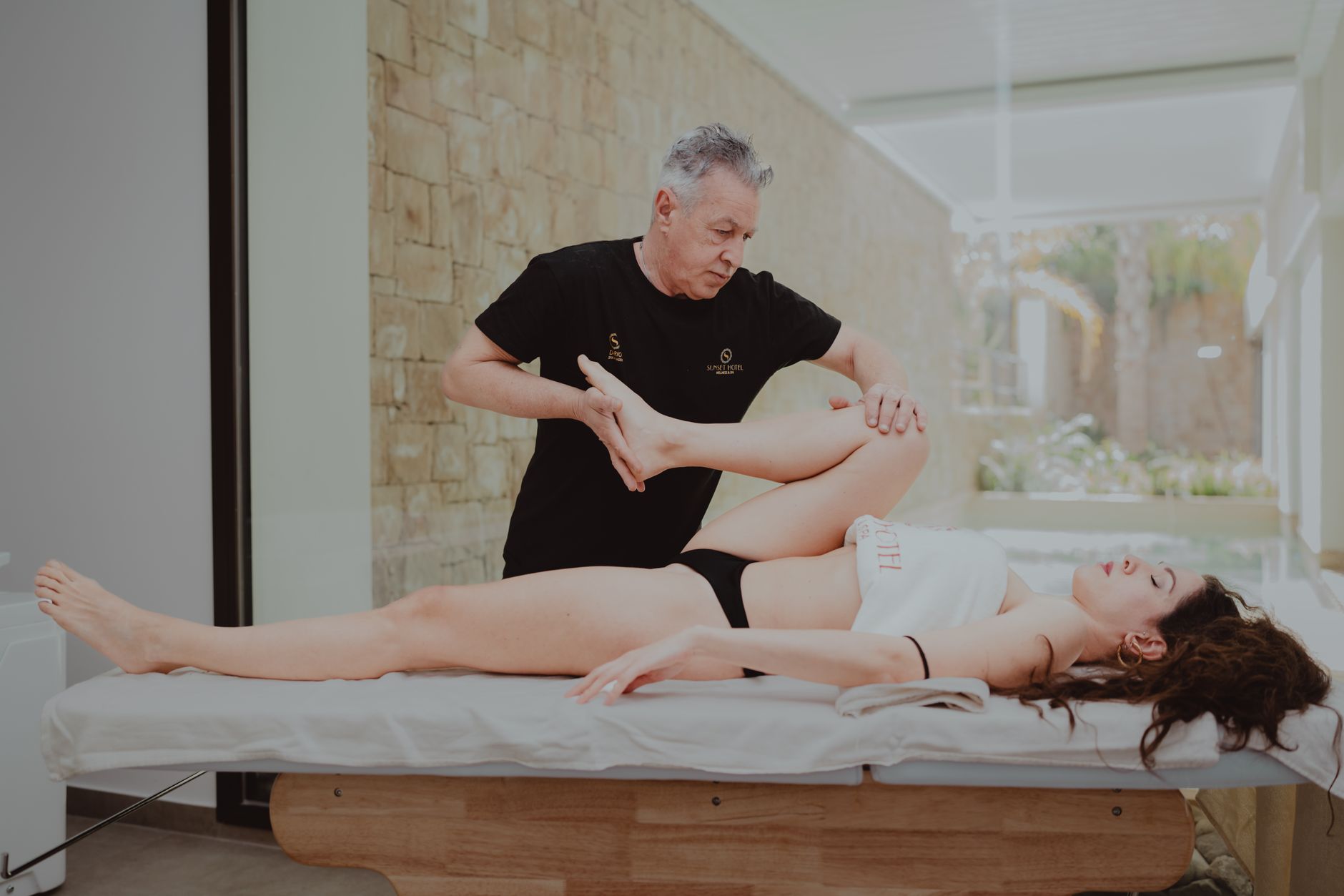 Therapist assists a patient with mobility exercises during an indoor rehabilitation session.