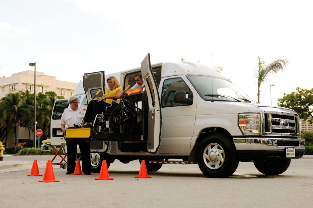 Wheelchair lift loading person into accessible van.
