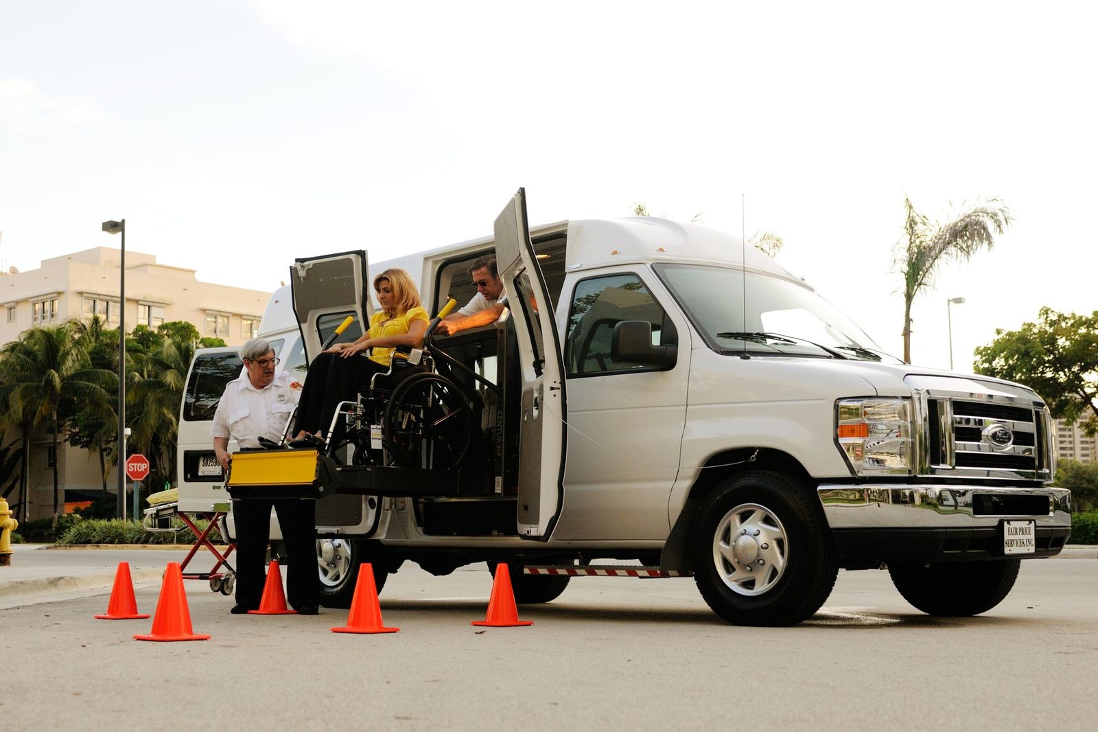 Wheelchair lift transferring person into accessible van.