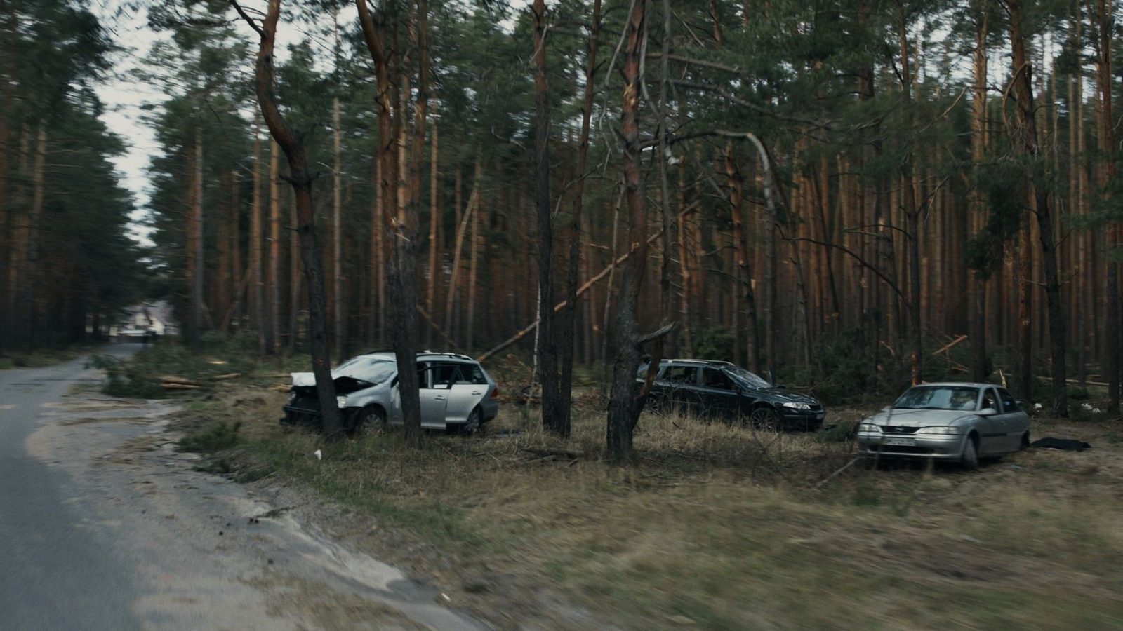 Damaged vehicles on a forest road after a car accident.