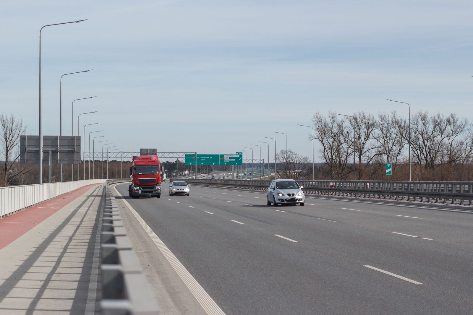 Highway traffic scene with multiple vehicles on a clear day.