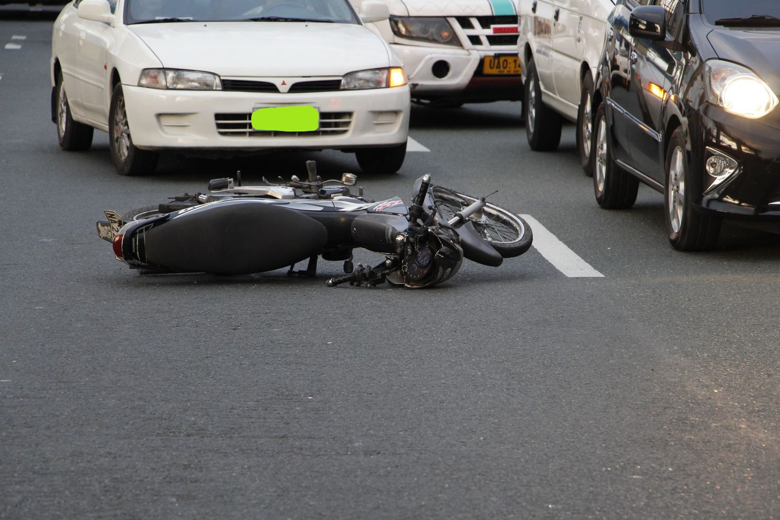 Motorcycle crashed on city road after accident.