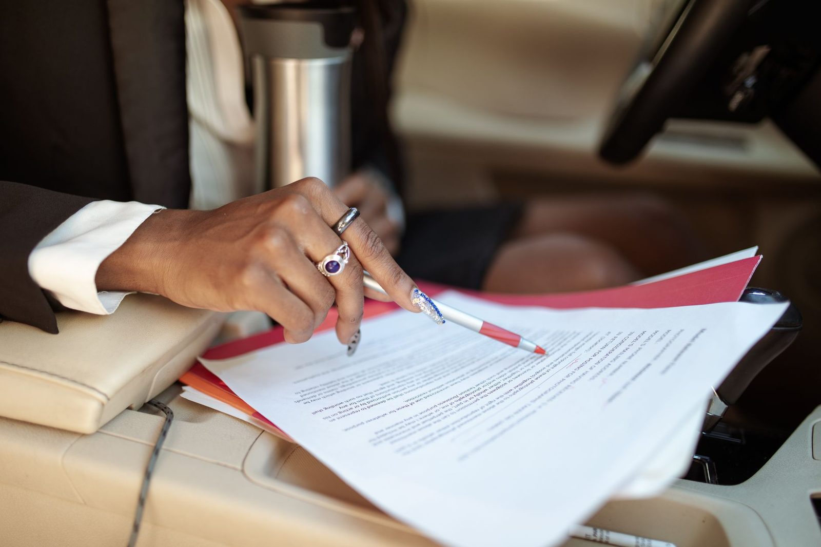 Professional reviewing accident claim documents inside a vehicle.
