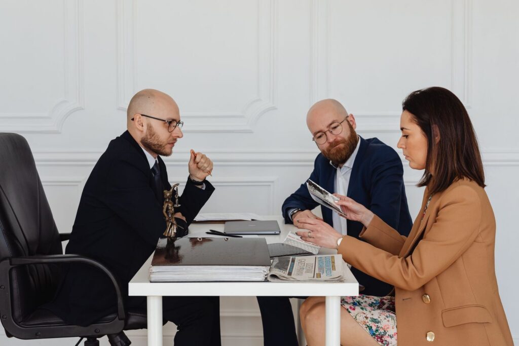 Professionals reviewing legal documents in an office consultation.