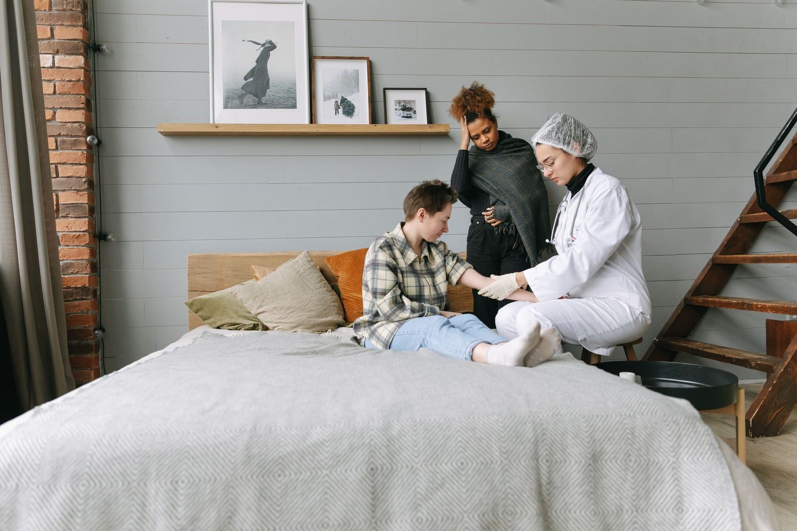 A doctor offers supportive care to a patient resting in a cozy bedroom.