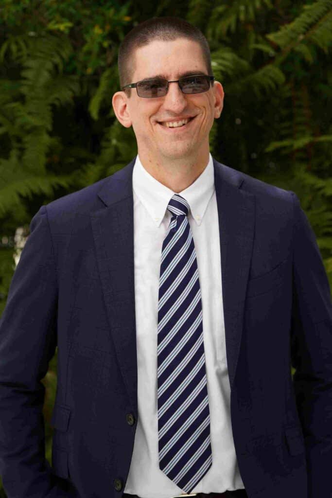 man in blue suit smiling