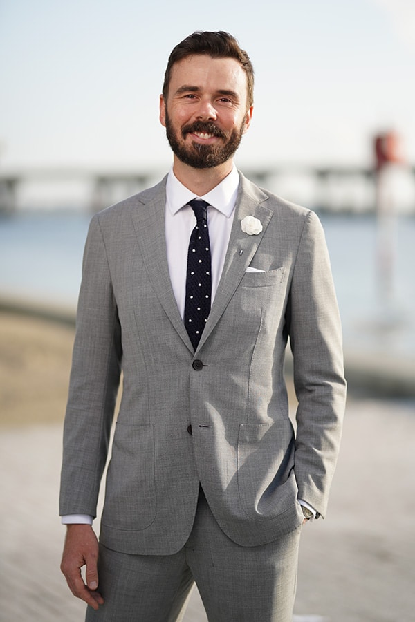 Gentleman in a gray suit by the water