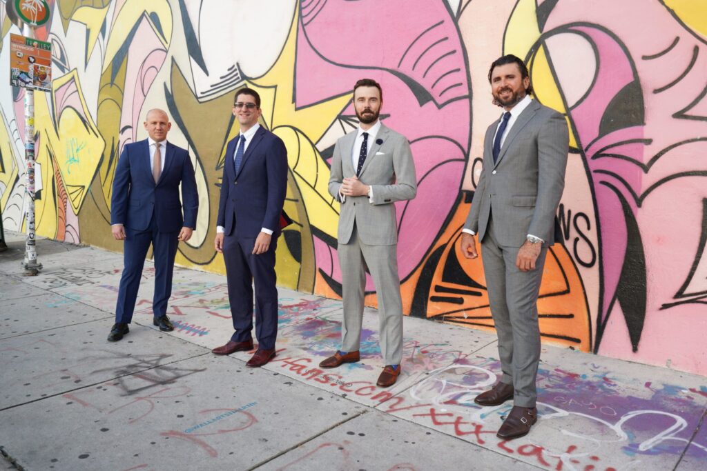 Men in suits against a graffiti backdrop