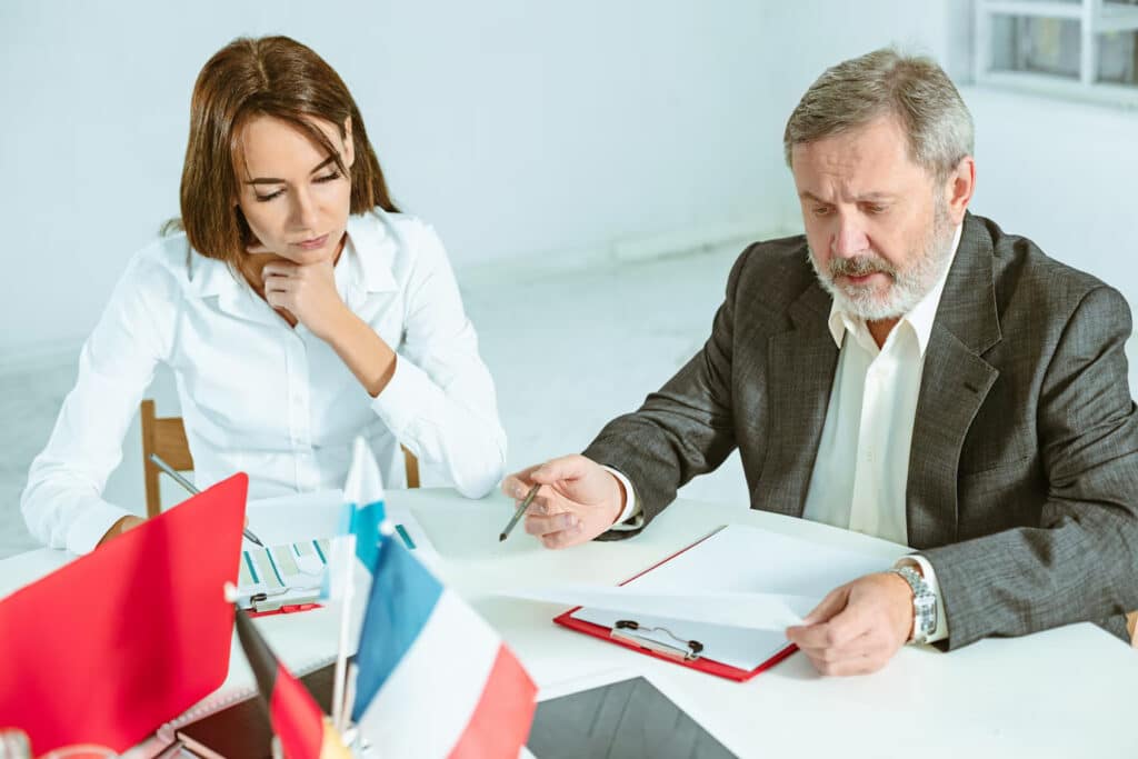 Two professionals discussing over documents