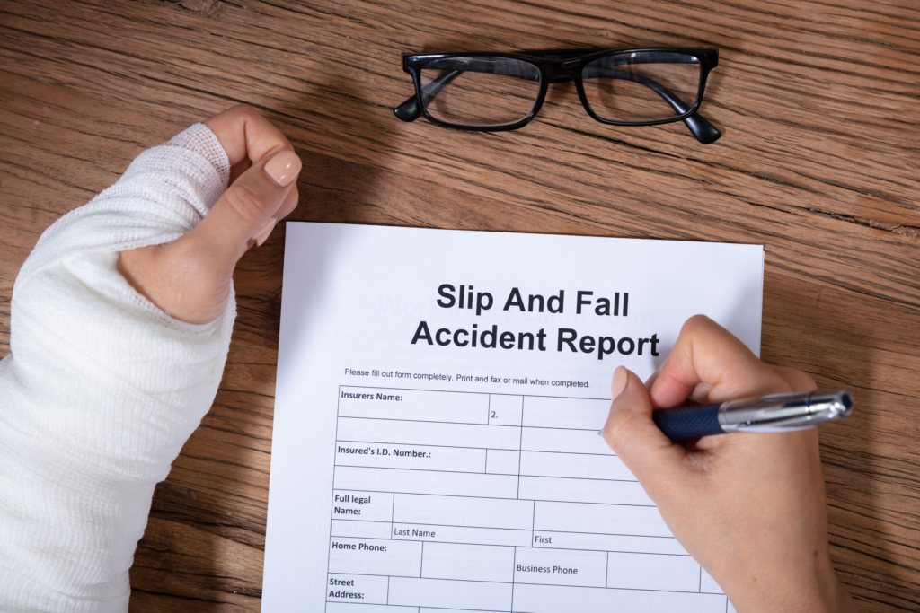 A person filling out a slip and fall accident form.