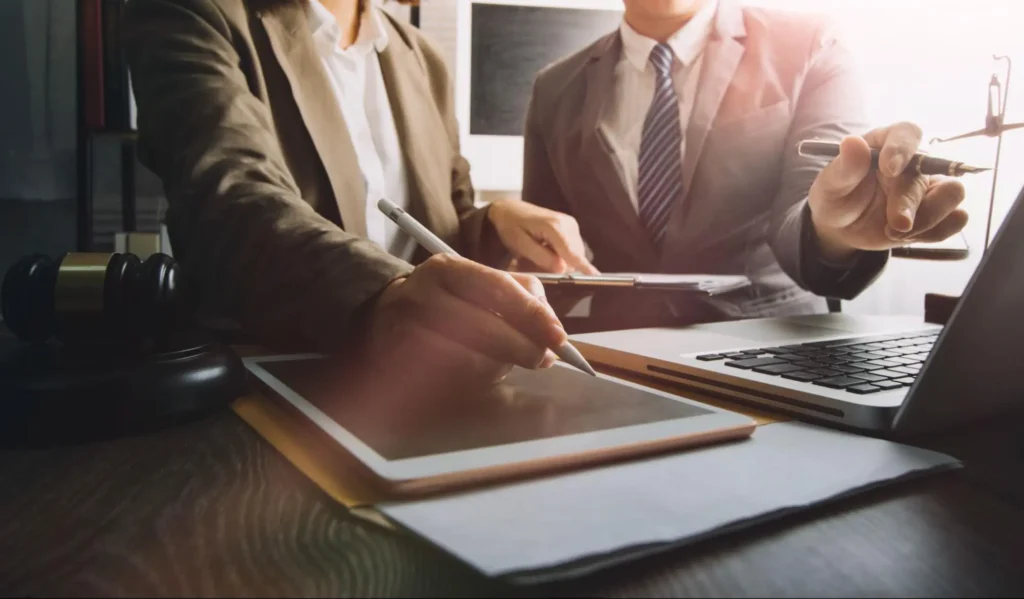 Lawyers working with digital tablet and laptop