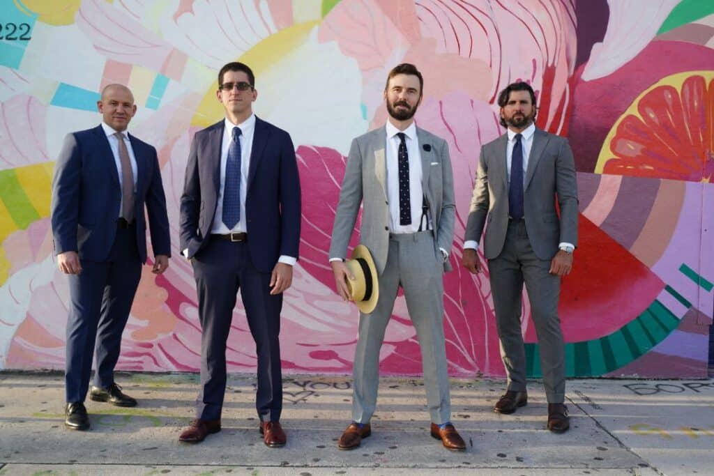 Men in suits against a graffiti backdrop