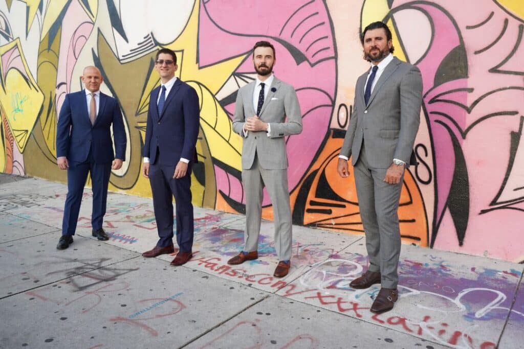 Men in suits against a graffiti backdrop